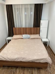 a bedroom with a large bed with a wooden headboard at Alina Home in Mediaş