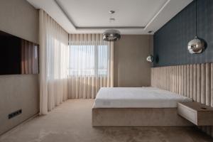 a bedroom with a bed and a large window at Villa Glam Wellness & Spa Retreat in Mogyoród