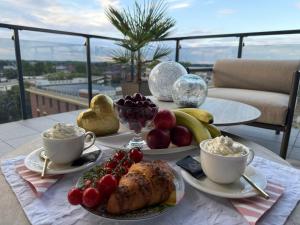 a table topped with plates of food and cups of coffee at Louise Luxury - free parking in Nyíregyháza