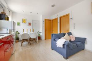 a living room with a blue couch and a table at Casa ELPI in Guardiola