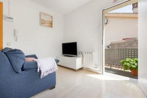 a living room with a blue couch and a television at Casa ELPI in Guardiola