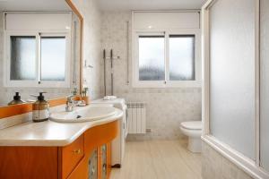 a bathroom with a sink and a toilet at Casa ELPI in Guardiola +17 photos