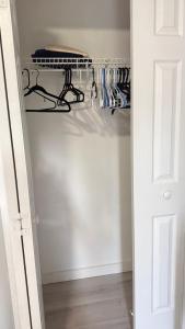 a closet with a white door and a shelf at Studio one bed in Clermont
