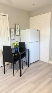 a dining room with a table and a refrigerator at Studio one bed in Clermont