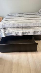 a mattress sitting on top of a wooden floor at Studio one bed in Clermont