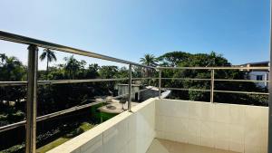 a balcony with a view of trees and palm trees at Hotel Nice Look Kuakata in Kuākāta +16 photos