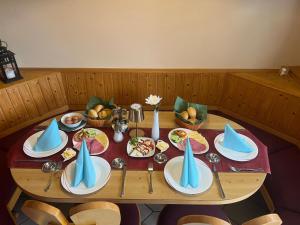 a wooden table with plates of food on it at Caldener Hof in Calden