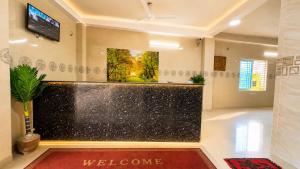 a lobby with a large aquarium in the middle of a room at Hotel Nice Look Kuakata in Kuākāta