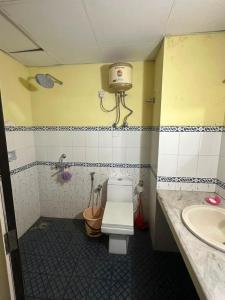 a bathroom with a toilet and a sink at ChriSeph in Kottayam +5 photos