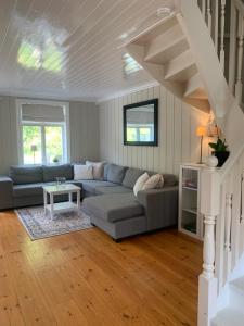 a living room with a couch and a table at Mølleråsen Apartment in Sandefjord