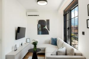 a living room with a couch and a table at One bedroom Belane Rezident in Tivat +1 photo