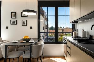 a kitchen with a table and chairs and a window at One bedroom Belane Rezident in Tivat