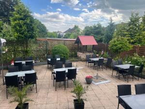 a patio with tables and chairs in a garden at Caldener Hof in Calden
