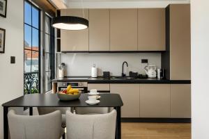 a kitchen with a table with a bowl of fruit on it at One bedroom Belane Rezident in Tivat