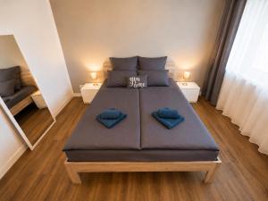 a bedroom with a large bed with blue pillows at Apartment Hannover - Langenhagen center in Hannover