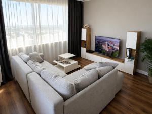 a living room with a couch and a large window at Apartment Hannover - Langenhagen center in Hannover