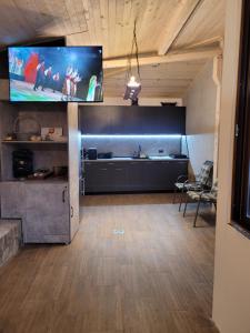 a large living room with a flat screen tv on the wall at Къща Чолаков и син - стаи за гости in Devin