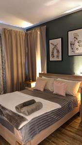 a bedroom with a large bed with pink pillows at Le Morne Kite Villas in La Gaulette +21 photos