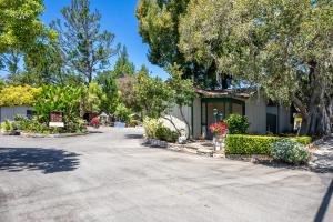 a house with trees and a driveway at Carmel Resort Inn in Carmel