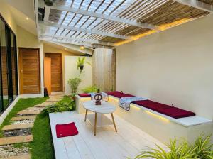 a patio with a bench and a table at The Arya Srithanu in Ko Kong Nui +1 photo