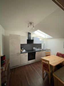 a kitchen with a table and a dining room at Gästehaus Zwischenberger in Obervellach