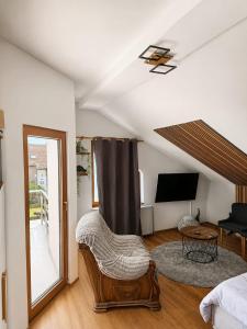a living room with a bed and a tv at Lucija in Tenja