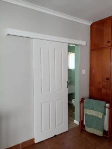 a white door in a room with a bathroom at 47atKabega in Gqeberha
