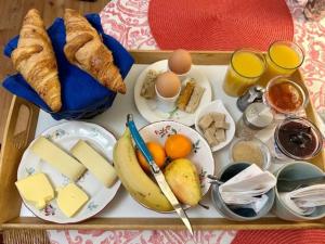 a tray of food with cheese and bread and eggs at chambre d'hôte les avettes in Réméréville