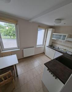a kitchen with a large window and a counter top at Dom na Kościelnej in Ślesin
