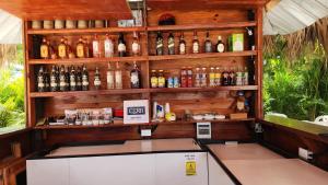 a bar with a lot of bottles of alcohol at Boca de Yuma Adventure in Yuma
