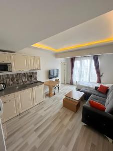 a living room with a couch and a kitchen at Air Otel in Trabzon