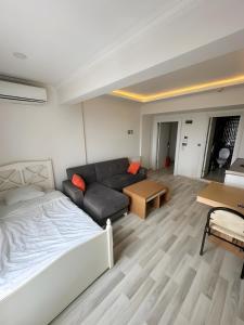 a living room with a bed and a couch at Air Otel in Trabzon