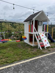 a small house with a slide and a playground at Elis Village in Sadova