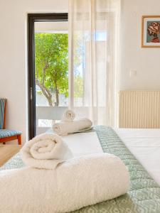a bedroom with a bed with towels on it at Blossom Apartment Kos in Ampavris