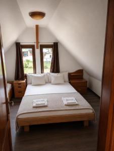 a bedroom with a bed in a attic at Coco & Simi Lakeside Nest in Cinciş