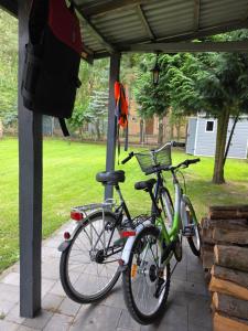 two bikes are parked under a shelter at Odpoczynkowo in Orle