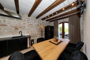 a dining room with a wooden table and black chairs at Filindvor in Nin