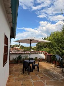 a table with an umbrella on a patio at Casa Garaje in Barichara