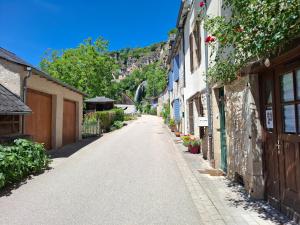an empty street in a town with a mountain at La Vie Est Belle in Salles-la-Source