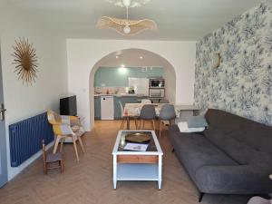a living room with a couch and a table at La Vie Est Belle in Salles-la-Source