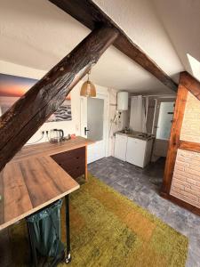 a kitchen with a wooden counter in a attic at Gästezimmer in Hafennähe in Waren