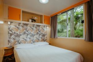 a bedroom with a bed and a large window at Green Garden Village con piscina, spiaggia riservata e parcheggio in Sirolo +57 photos