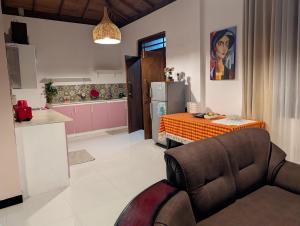 a kitchen and living room with a couch and a table at Rest Harrow Estate in Kandy
