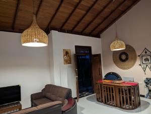 a living room with two pendant lights and a couch at Rest Harrow Estate in Kandy