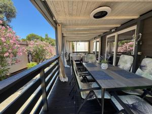 a wooden deck with a table and chairs at Danyja Mobilehome in Biograd na Moru