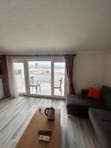 a living room with a couch and a view of the ocean at Air Otel in Trabzon