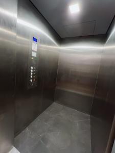 a elevator in a building with a metal wall at Hotel 2000 Valkenburg in Valkenburg