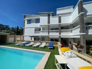 a villa with a swimming pool and a resort at Imani staycation Penthouse Diani in Diani Beach