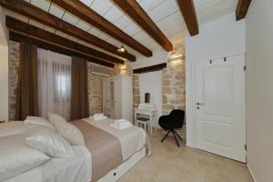 a bedroom with a bed and a desk in a room at Filindvor in Nin +31 photos