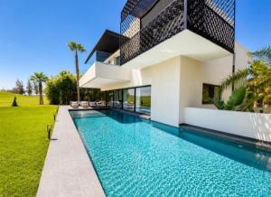 a house with a swimming pool in front of it at Luxury Premium Villa Golf Resort Private Pool in Marrakesh